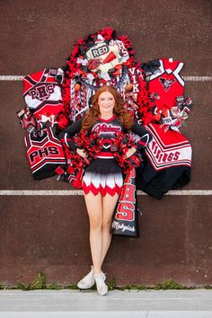 a cheerleader standing in front of a wall