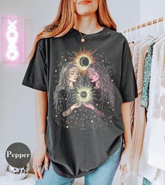 Cosmic Sisterhood Witchy Celestial Astrology Shirt Vintage Style Garment-Dyed Comfort Colors Tee Designed and printed in the USA Introducing our stunning Unisex Garment-Dyed T-shirt! This thoughtfully designed tee is perfect for individuals who appreciate laid-back, stylish fashion. Crafted from high-quality, 100% ring-spun US cotton, it offers long-lasting comfort for everyday wear. Ideal for casual outings, relaxed gatherings, or semi-formal events, it effortlessly transitions from day to night. It's a fantastic choice for those who celebrate individuality, making it a great gift for birthdays, holidays, or just because. With 58 colors available, there's a perfect shade for every personality. Enjoy the soft texture and unique look that garment-dyeing provides, ensuring you stand out in a Tarot Shirt, Sun And Moon Tarot, Astrology Shirt, Comfort Colors Tee, Look Plus, Stylish Fashion, Sun Moon, Soft Texture, Tee Design