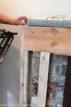 a man is working on an unfinished fireplace