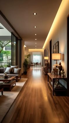 an empty living room with wood floors and large windows