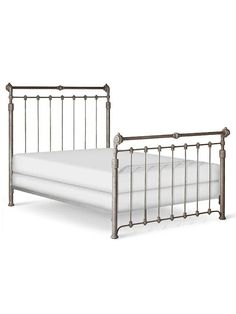 a metal bed frame with white sheets and pillows on top of it, viewed from the side