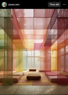 the room is filled with different colored squares and couches in front of large windows