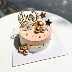 a birthday cake with gold decorations on top