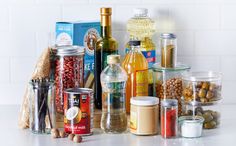 an assortment of spices and condiments sitting on a counter next to each other