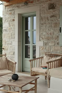 two wooden chairs sitting on top of a patio