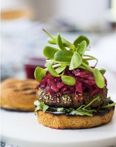 a burger with lettuce and red cabbage on it