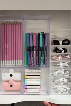 the drawers are organized with pens, pencils and other items