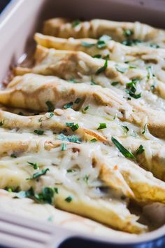 a casserole dish filled with chicken and cheese