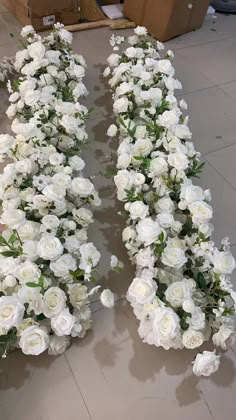 two rows of white flowers on the floor