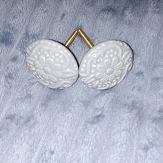 pair of white ceramic cufflinks with gold accents