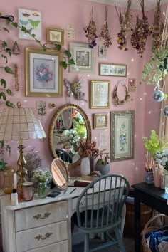 a room filled with lots of different types of plants and pictures hanging on the wall