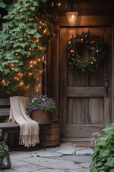 a wooden bench sitting next to a door covered in plants and wreaths with lights on them