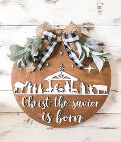 a wooden sign that says christ the savor is born with a nativity scene on it