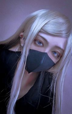 a woman with blonde hair wearing a black mask