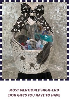 a basket filled with lots of items sitting on top of a wooden table next to a white and black checkered wall