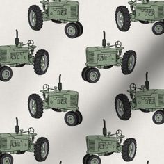 a blue tractor on a white background with black and gray wheels is the centerpiece of this fabric