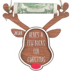 a wooden reindeer ornament with the words here's a few bucks for christmas