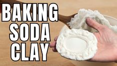 a hand holding a wooden spoon over a bowl filled with white substance and the words baking soda clay