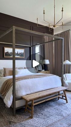 a bedroom with a canopy bed sitting next to a window