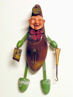 a wooden toy with a man holding a fishing rod and an umbrella on it's back