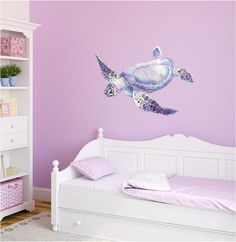 a child's bedroom with purple walls and white furniture