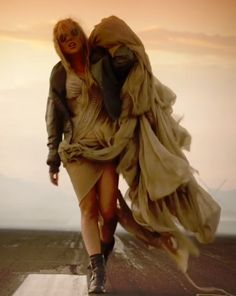 a woman walking across a runway in the desert