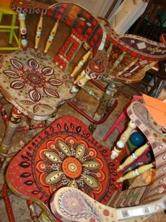 several colorful chairs sitting on top of a floor next to each other in a room