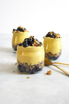 three jars filled with food sitting on top of a table