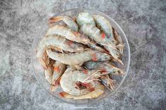 a bowl filled with shrimp sitting on top of a table