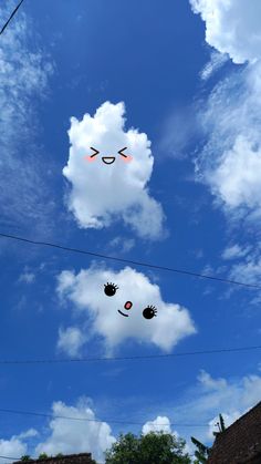 three kites flying in the sky above some houses