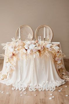 the table is decorated with flowers and chairs