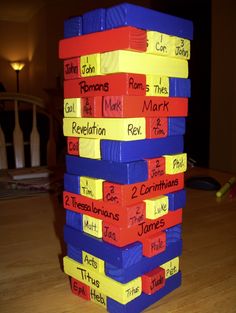 a stack of blocks with words written on them sitting on top of a wooden table