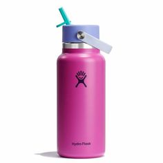 the hydro flask water bottle is pink and has a blue lid with a green straw sticking out of it