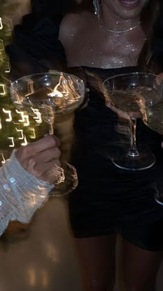 two people holding up wine glasses in front of their faces with the caption's name on them