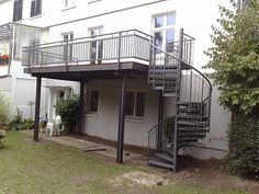 a white house with a metal stair case