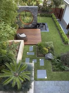 an aerial view of a garden with grass, rocks and plants in the middle of it