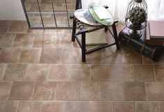 a chair and table in a room with tile flooring