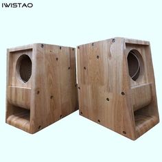 two wooden speakers sitting side by side on top of each other in front of a white background