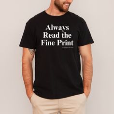 a man wearing a black t - shirt that says, always read the fine print