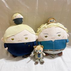 two stuffed dolls sitting next to each other