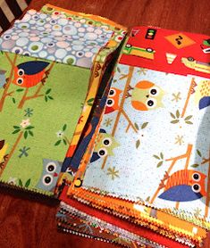 four different fabrics are stacked on top of each other in the shape of owls and trees