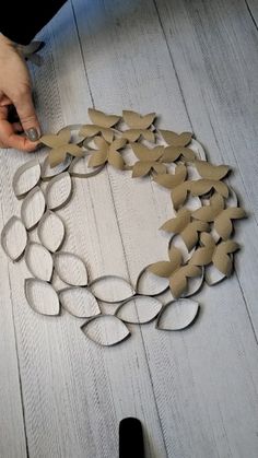 someone is making a wreath out of cardboard