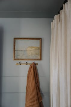 a towel hanging on the wall next to a painting