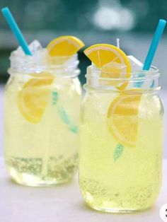 two mason jars filled with lemonade and ice