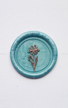 a small blue plate with a flower on it