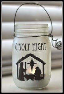 a white mason jar with a nativity scene on the front and red border around it