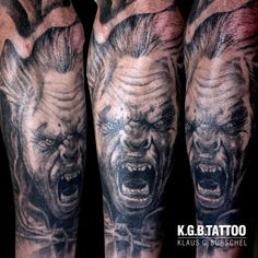 two men with tattoos on their arms and hands, one has an evil clown face