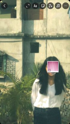 a woman with long hair standing in front of a building