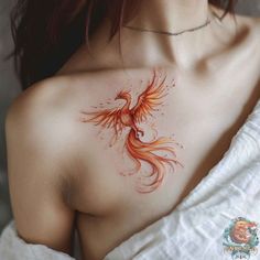 a woman with a tattoo on her chest has a red bird painted on it's chest