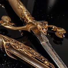 an elaborate gold and silver knife on a black surface